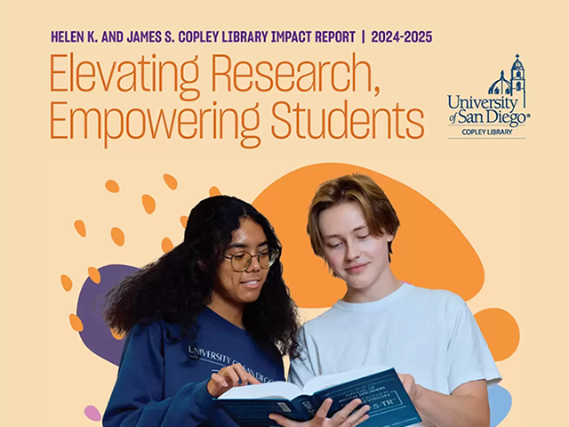 image of two college students looking at a book